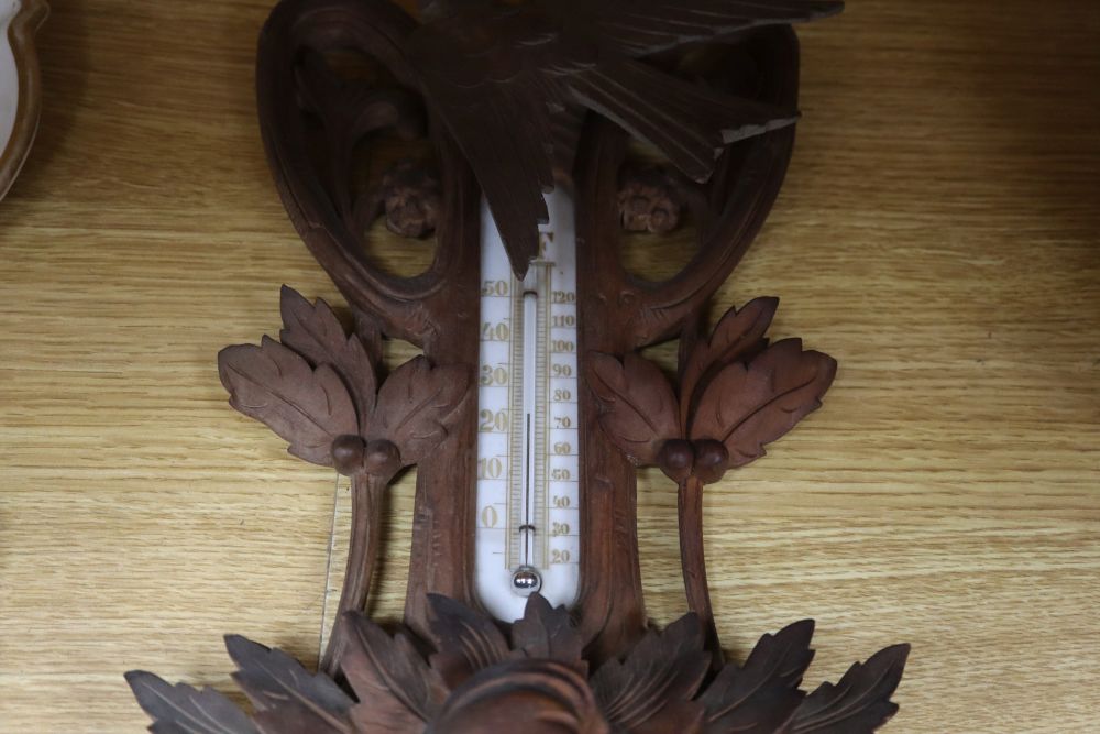 A Black Forest carved wall barometer, height 62cm
